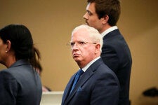 John Eastman, a former lawyer for the Trump campaign, during his arraignment with his lawyers in Maricopa County Superior Court last month.