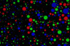 Droplets containing RNA float in water. Each color is produced by a different kind of RNA.