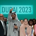 Sultan al-Jaber, the president of the COP28 summit in Dubai last year, center, with other officials. The Dubai summit yielded a resolution that for the first time called for decarbonizing the world’s energy system.