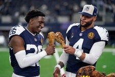 DaRon Bland, left, and Dak Prescott of the Dallas Cowboys after defeating the Washington Commanders 45-10 on Nov. 23, 2023. The Cowboys have played a Thanksgiving Day game every year except two since 1966.